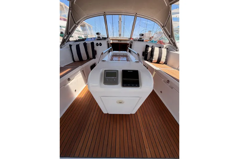 Slide: The Image of 2014 Jeanneau Sun Odyssey 509 cockpit with wood flooring and striped cushions. - 26