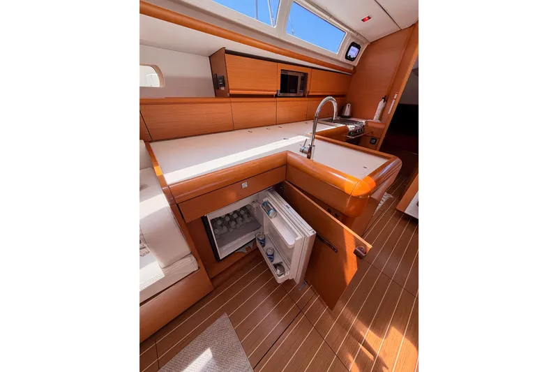 Slide: The Image of Modern kitchen interior of 2014 Jeanneau Sun Odyssey 509 yacht with open fridge. - 54