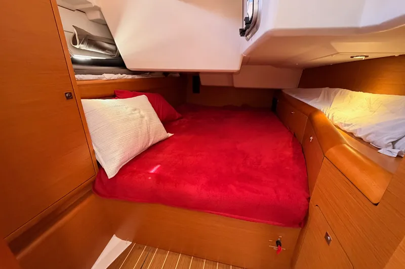 Slide: The Image of Cozy cabin interior of 2014 Jeanneau Sun Odyssey 509 with red bedding. - 58