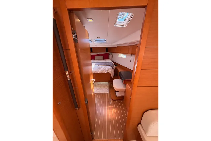 Slide: The Image of Interior cabin of 2014 Jeanneau Sun Odyssey 509 yacht, featuring cozy bed and wooden finish. - 84