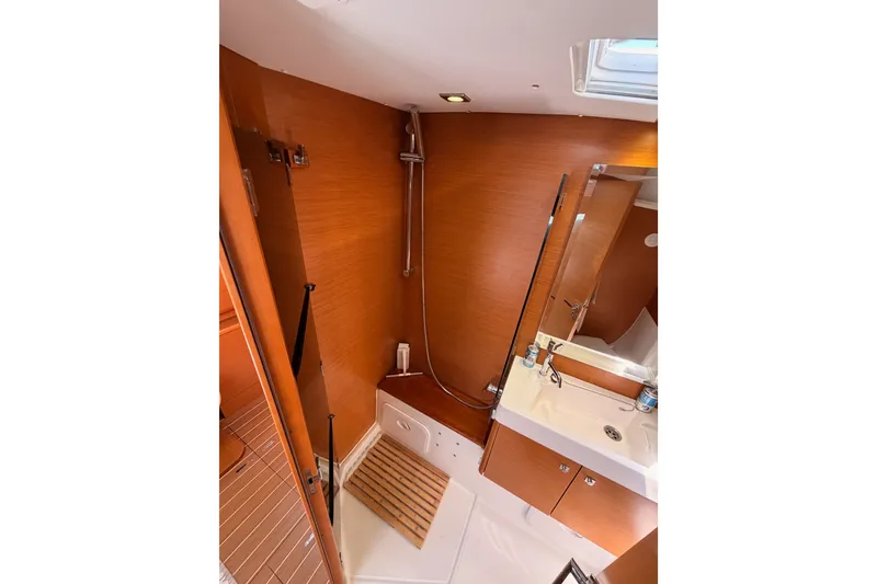 Slide: The Image of Bathroom interior of 2014 Jeanneau Sun Odyssey 509 yacht, featuring wooden finishes and modern fixtures. - 89