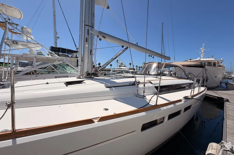 Slide: The Image of 2014 Jeanneau Sun Odyssey 509 sailboat docked at marina under clear blue sky. - 10