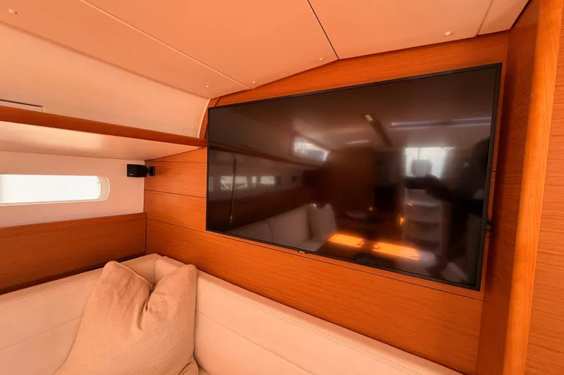 Slide: The Image of Interior of 2014 Jeanneau Sun Odyssey 509 yacht with wall-mounted TV and cozy seating. - 81