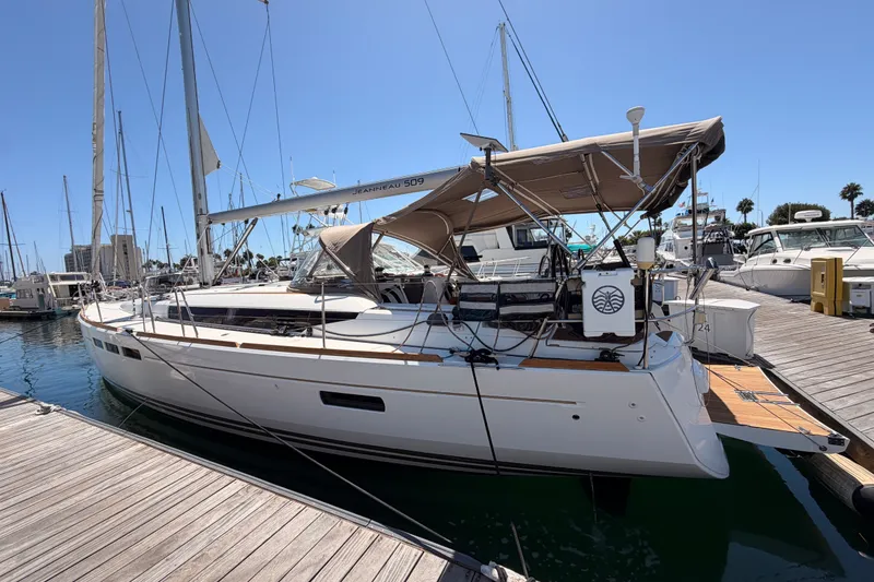 Slide: The Image of 2014 Jeanneau Sun Odyssey 509 sailboat docked at marina under clear blue sky. - 5