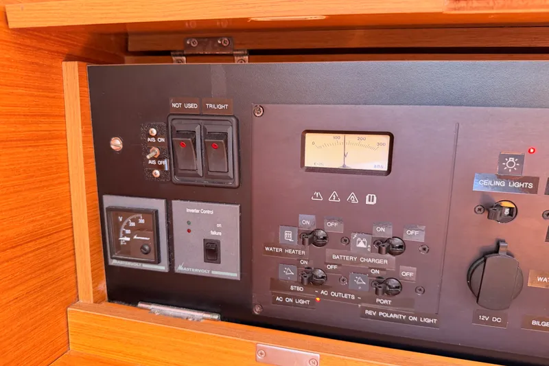 Slide: The Image of Control panel of a 2014 Jeanneau Sun Odyssey 509 sailboat, featuring switches and gauges. - 75