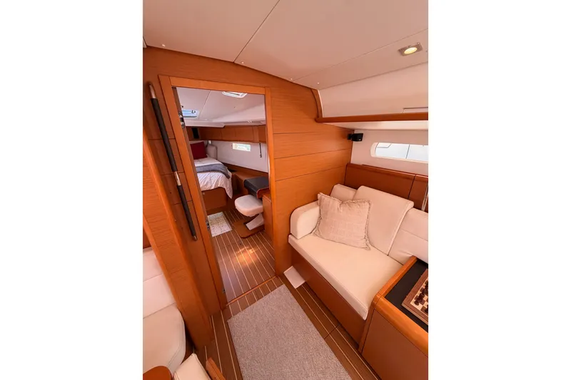 Slide: The Image of Interior of 2014 Jeanneau Sun Odyssey 509 yacht, featuring cozy seating and elegant wood finishes. - 82