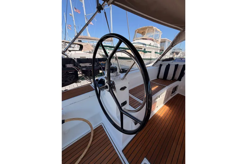 Slide: The Image of Steering wheel of 2014 Jeanneau Sun Odyssey 509 sailboat, docked with visible deck and seating. - 27