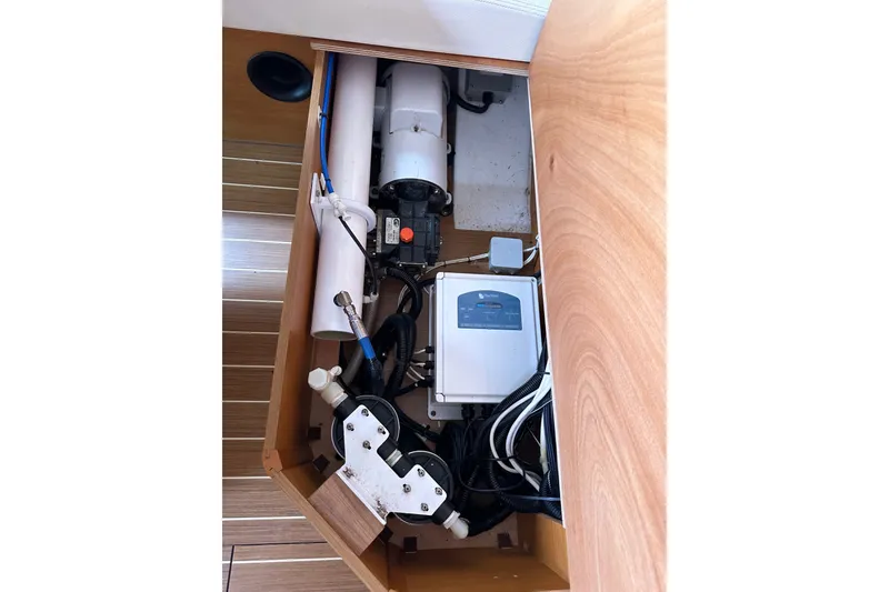 Slide: The Image of Interior view of Jeanneau Sun Odyssey 509 yacht's technical compartment, showcasing equipment and wiring. - 110