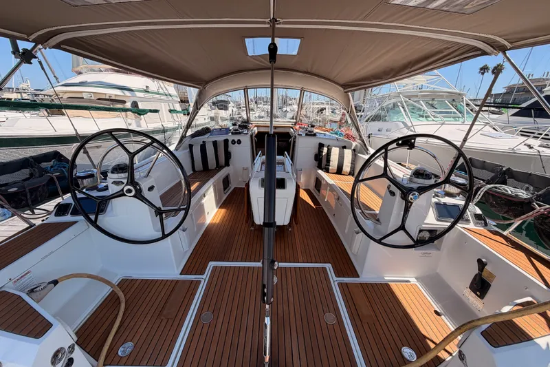 Slide: The Image of 2014 Jeanneau Sun Odyssey 509 yacht interior with dual steering wheels and teak flooring. - 18