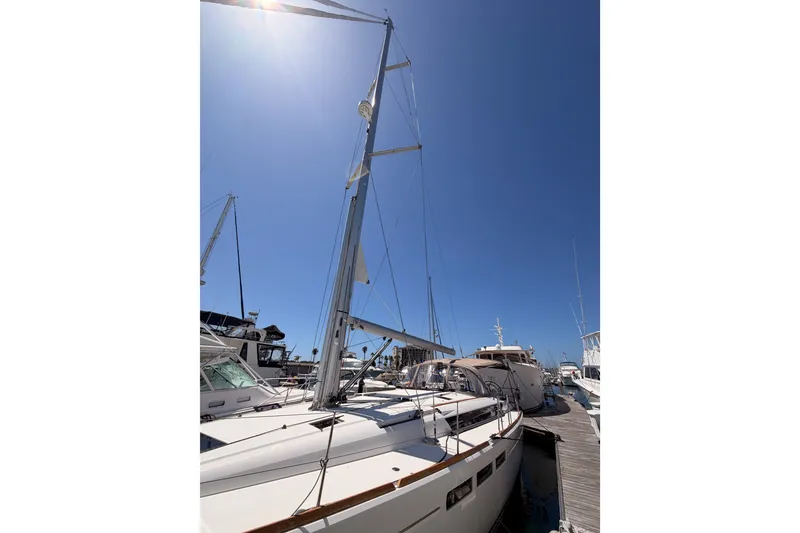 Slide: The Image of 2014 Jeanneau Sun Odyssey 509 sailboat docked under clear blue sky. - 9