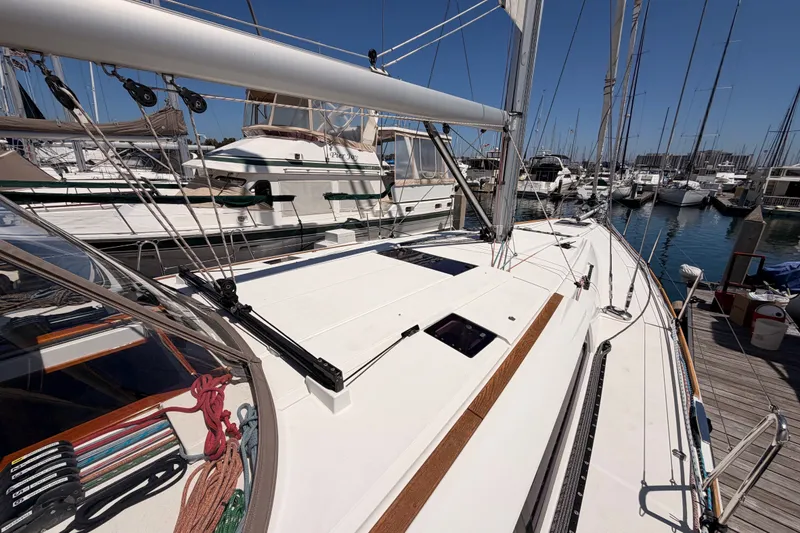 Slide: The Image of 2014 Jeanneau Sun Odyssey 509 sailboat docked at marina, showcasing deck and rigging. - 31