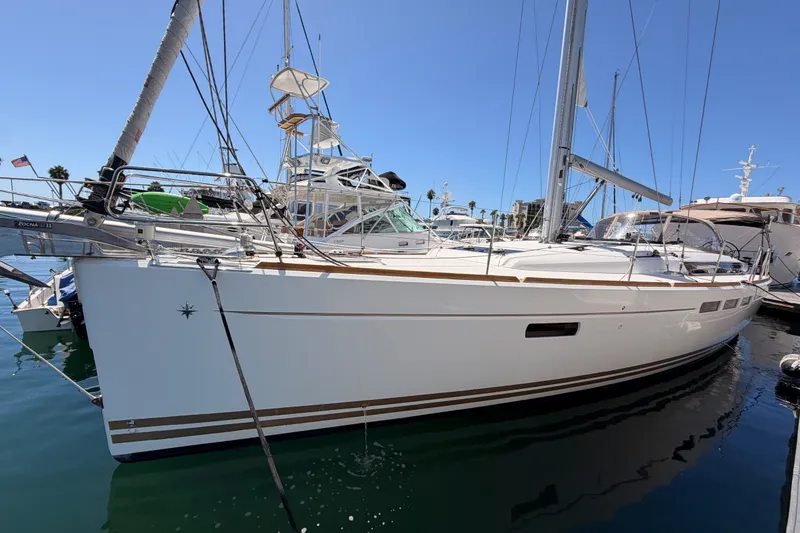Slide: The Image of 2014 Jeanneau Sun Odyssey 509 sailboat docked in marina, clear blue sky. - 8