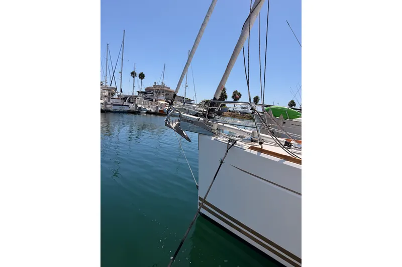 Slide: The Image of 2014 Jeanneau Sun Odyssey 509 yacht docked in a marina under clear blue skies. - 6