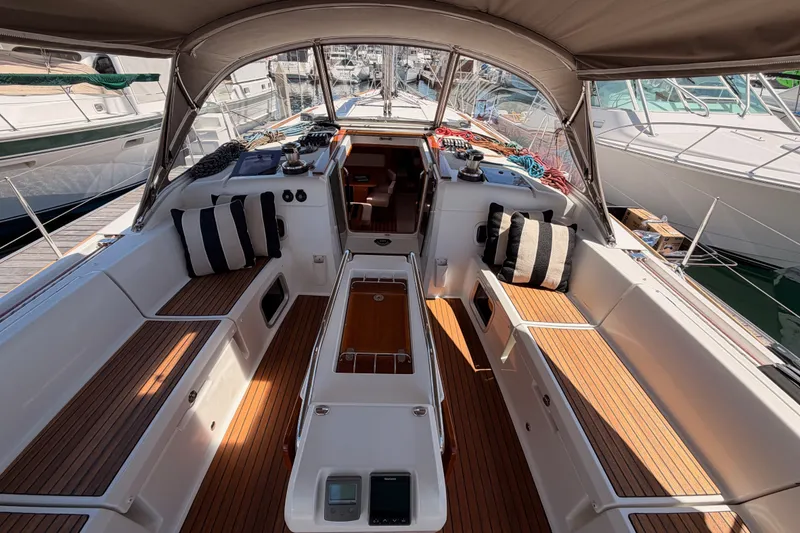 Slide: The Image of Cockpit of 2014 Jeanneau Sun Odyssey 509 sailboat with teak flooring and striped cushions. - 47