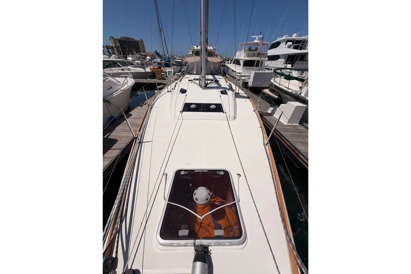 Slide: The Image of 2014 Jeanneau Sun Odyssey 509 sailboat docked at marina, showcasing deck and hatch. - 40