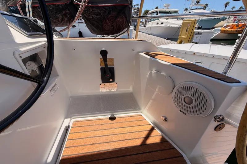 Slide: The Image of Cockpit of 2014 Jeanneau Sun Odyssey 509 with teak flooring and control panel. - 21