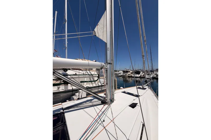 Slide: The Image of 2014 Jeanneau Sun Odyssey 509 sailboat docked in marina, showcasing mast and rigging. - 32