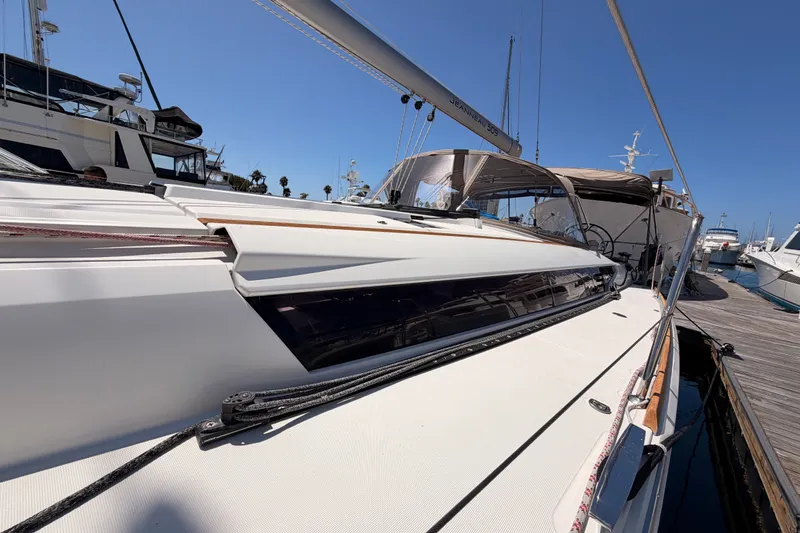 Slide: The Image of 2014 Jeanneau Sun Odyssey 509 sailboat docked at marina under clear blue sky. - 12