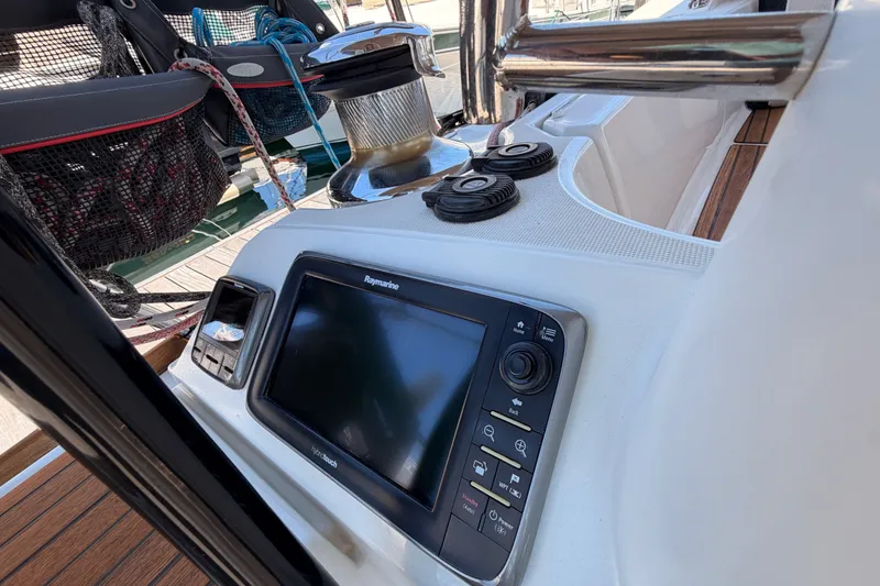 Slide: The Image of Cockpit of 2014 Jeanneau Sun Odyssey 509 with navigation equipment and winch. - 28