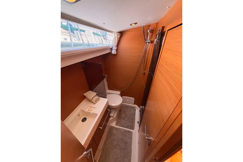 Slide: The Image of Bathroom interior of 2014 Jeanneau Sun Odyssey 509 yacht, featuring modern fixtures and wood paneling. - 62