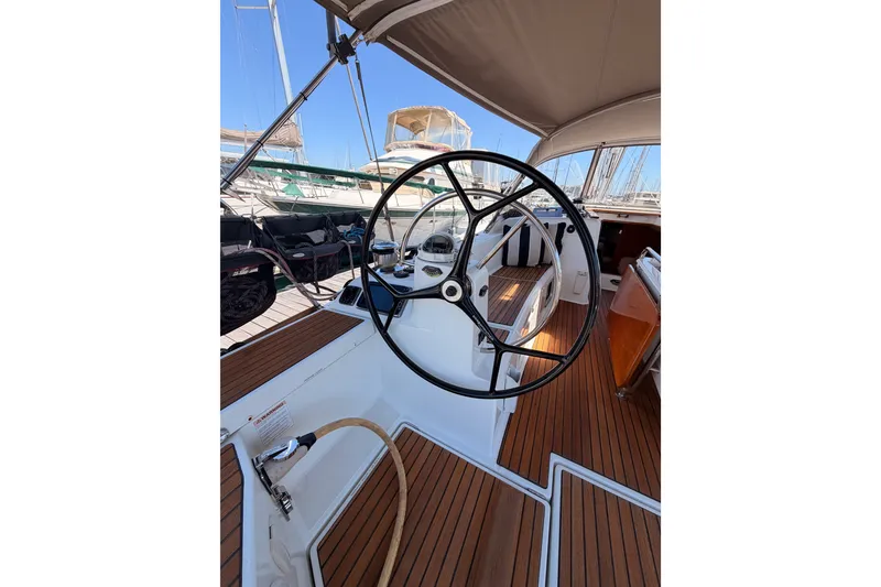 Slide: The Image of Steering wheel of 2014 Jeanneau Sun Odyssey 509 sailboat, featuring teak deck. - 19