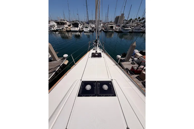 Slide: The Image of 2014 Jeanneau Sun Odyssey 509 yacht docked in a marina, surrounded by boats. - 34