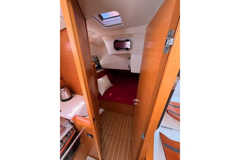 Slide: The Image of Interior cabin of 2014 Jeanneau Sun Odyssey 509 sailboat, featuring wood finish and cozy bedding. - 57
