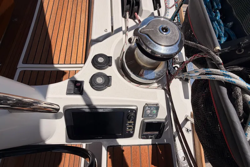 Slide: The Image of Cockpit controls of a 2014 Jeanneau Sun Odyssey 509 sailboat with winch and ropes. - 24