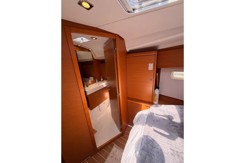 Slide: The Image of Interior of 2014 Jeanneau Sun Odyssey 509 yacht, featuring a cozy cabin and bathroom. - 88
