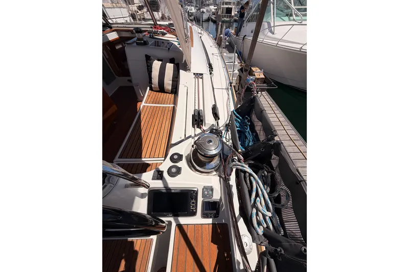 Slide: The Image of 2014 Jeanneau Sun Odyssey 509 sailboat deck with winch and ropes in marina. - 25