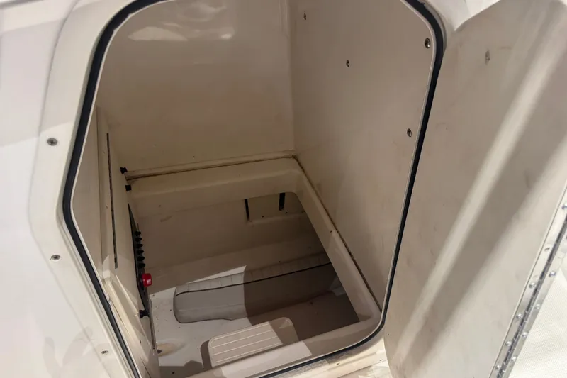 Slide: The Image of Storage compartment inside a 2015 Mako 214 Center Console boat. - 13