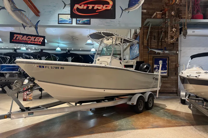 Slide: The Image of 2015 Mako 214 Center Console boat on trailer in showroom. - 3