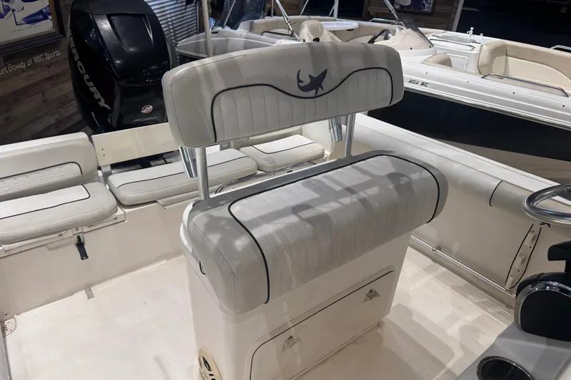 Slide: The Image of 2015 Mako 214 Center Console boat interior with seating and Mercury engine. - 6
