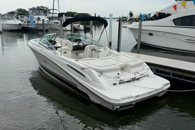 The Image of 2007 Sea Ray SLX 250 boat docked in a marina with other vessels. - 1
