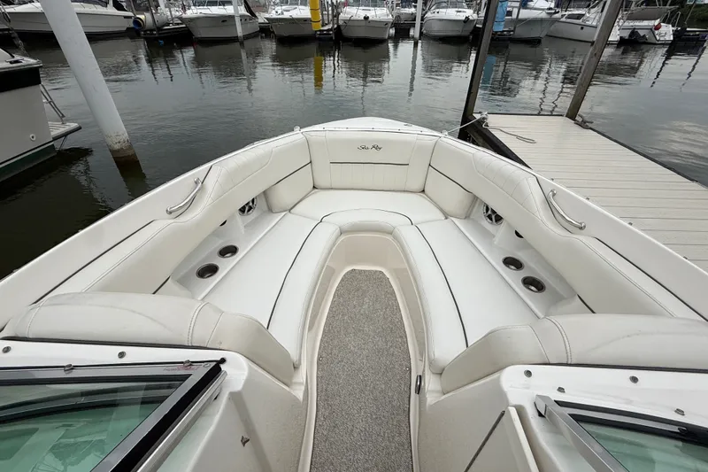 Slide: The Image of Luxurious 2007 Sea Ray SLX 250 boat interior with white seating at marina. - 25