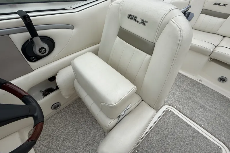 Slide: The Image of Interior of a 2007 Sea Ray SLX 250 boat, featuring white seating and steering controls. - 17