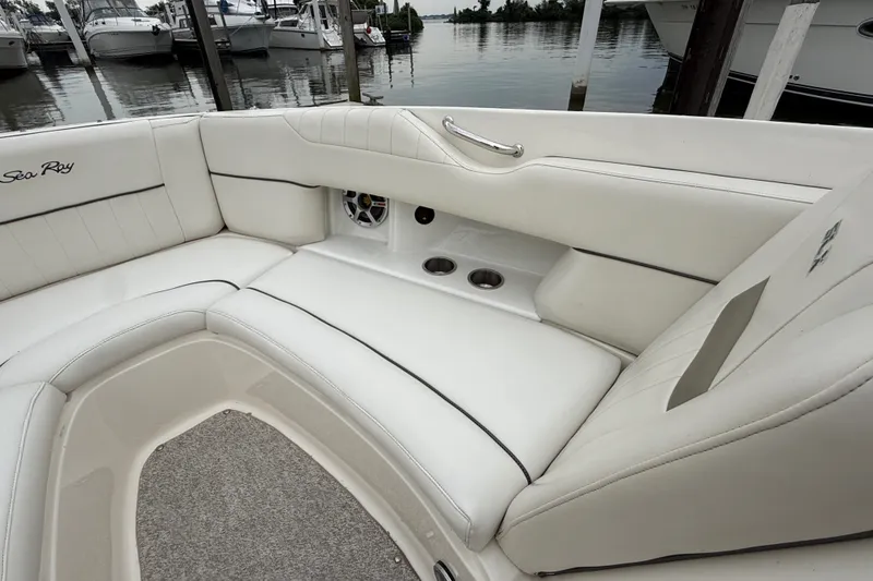 Slide: The Image of Luxurious interior of 2007 Sea Ray SLX 250 boat with white seating and cup holders. - 26