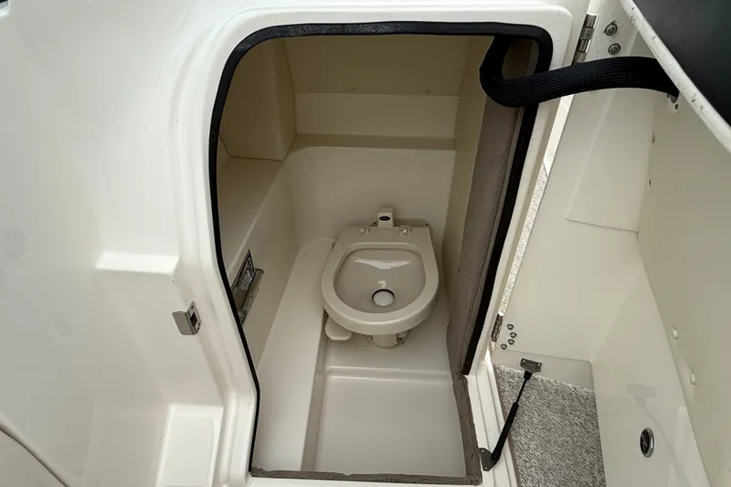 Slide: The Image of 2007 Sea Ray SLX 250 boat interior with compact marine toilet. - 22