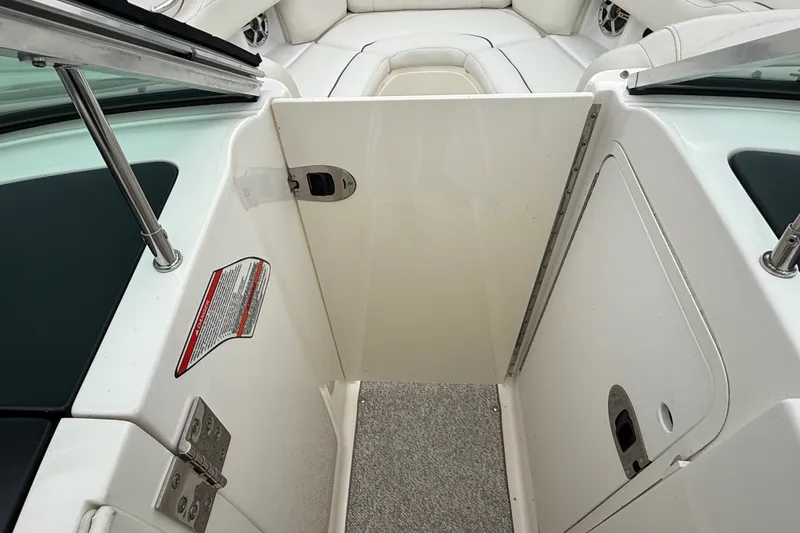 Slide: The Image of 2007 Sea Ray SLX 250 boat interior with open door and seating area. - 23