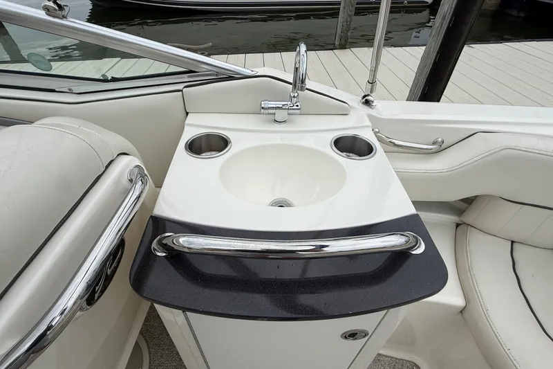 Slide: The Image of 2007 Sea Ray SLX 250 boat interior with sink and cup holders. - 9