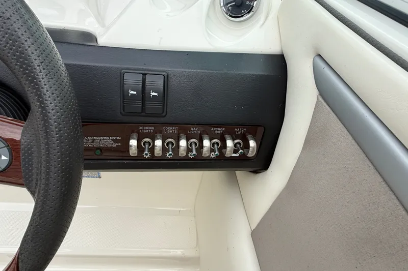 Slide: The Image of Control panel of a 2007 Sea Ray SLX 250 boat with various switches. - 21