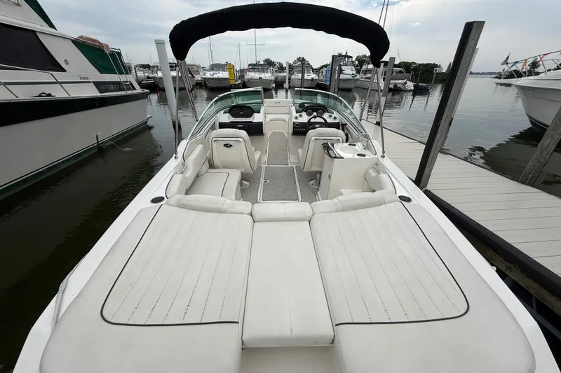 Slide: The Image of 2007 Sea Ray SLX 250 boat docked, featuring spacious seating and sleek design. - 7