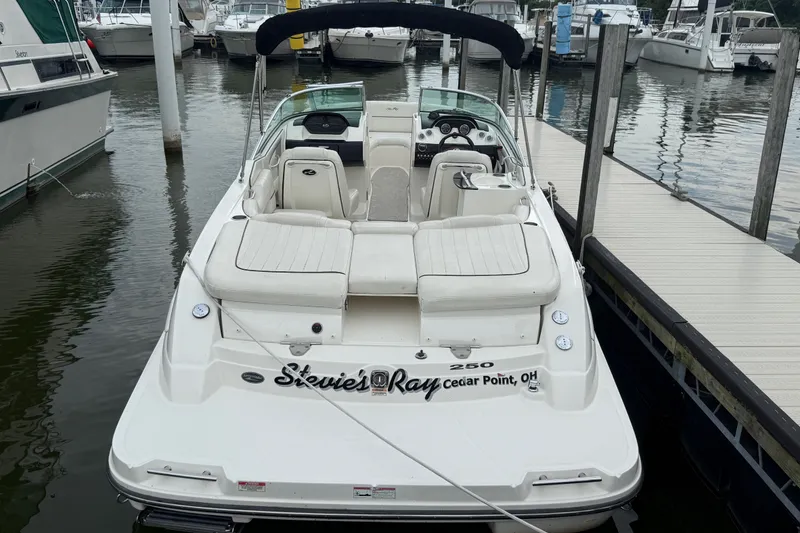 Slide: The Image of 2007 Sea Ray SLX 250 boat docked at marina, featuring spacious seating and sleek design. - 2