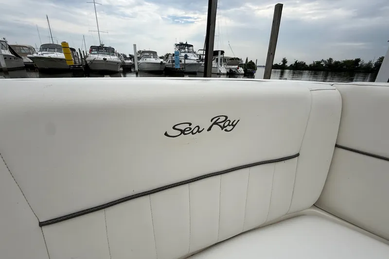 Slide: The Image of 2007 Sea Ray SLX 250 boat interior with logo, docked at marina. - 27