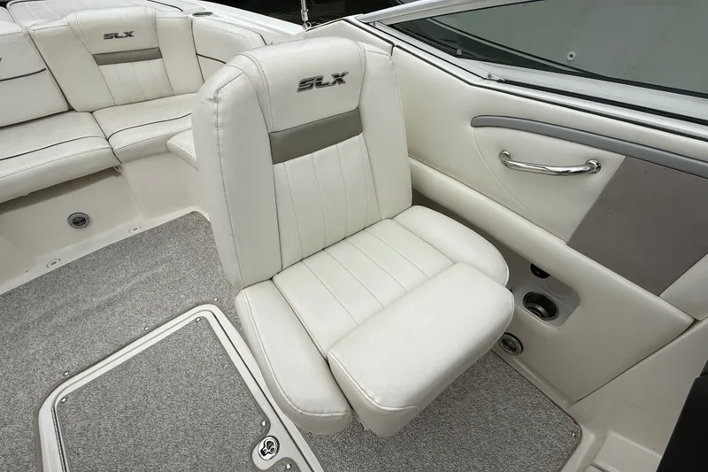 Slide: The Image of 2007 Sea Ray SLX 250 boat interior with white leather seating and carpeted flooring. - 13