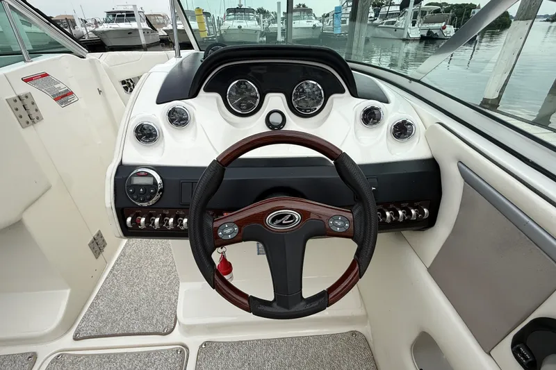 Slide: The Image of Steering wheel and dashboard of a 2007 Sea Ray SLX 250 boat at a marina. - 18