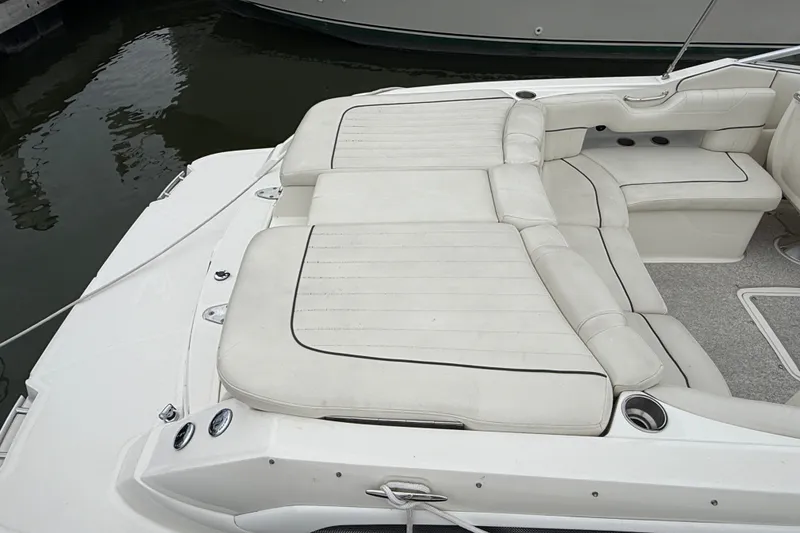 Slide: The Image of 2007 Sea Ray SLX 250 boat with spacious white leather seating and cup holders. - 4