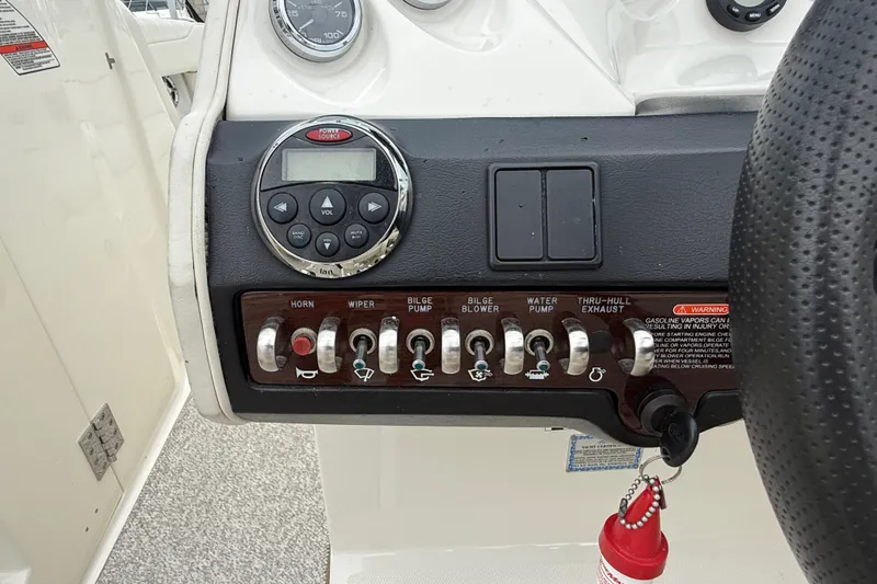 Slide: The Image of Control panel of a 2007 Sea Ray SLX 250 boat with switches and gauges. - 20