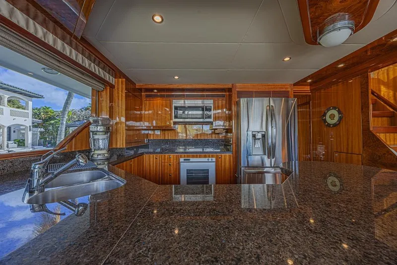 Slide: The Image of Luxurious kitchen interior of 2010 Ocean Alexander 74 Motoryacht with modern appliances and wood finish. - 30