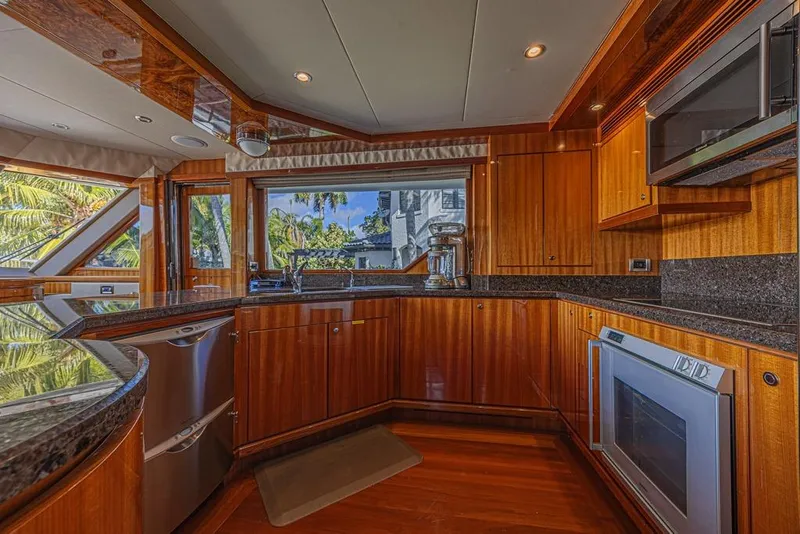 Slide: The Image of Luxurious kitchen interior of 2010 Ocean Alexander 74 Motoryacht with wood cabinetry and modern appliances. - 31